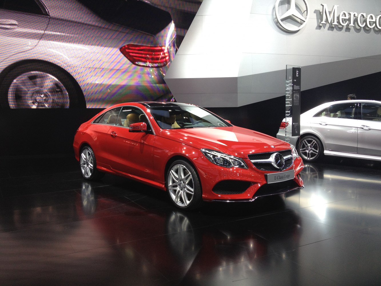 Red luxury coupe with sleek front grille and sporty alloy wheels