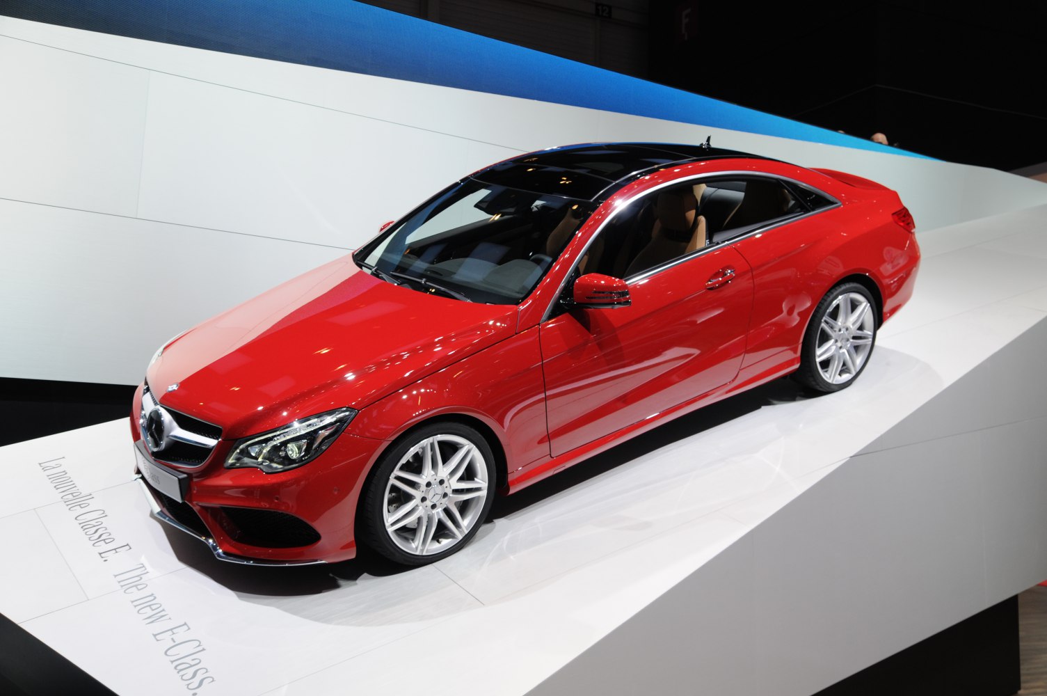 Red two-door coupe with panoramic sunroof and alloy wheels