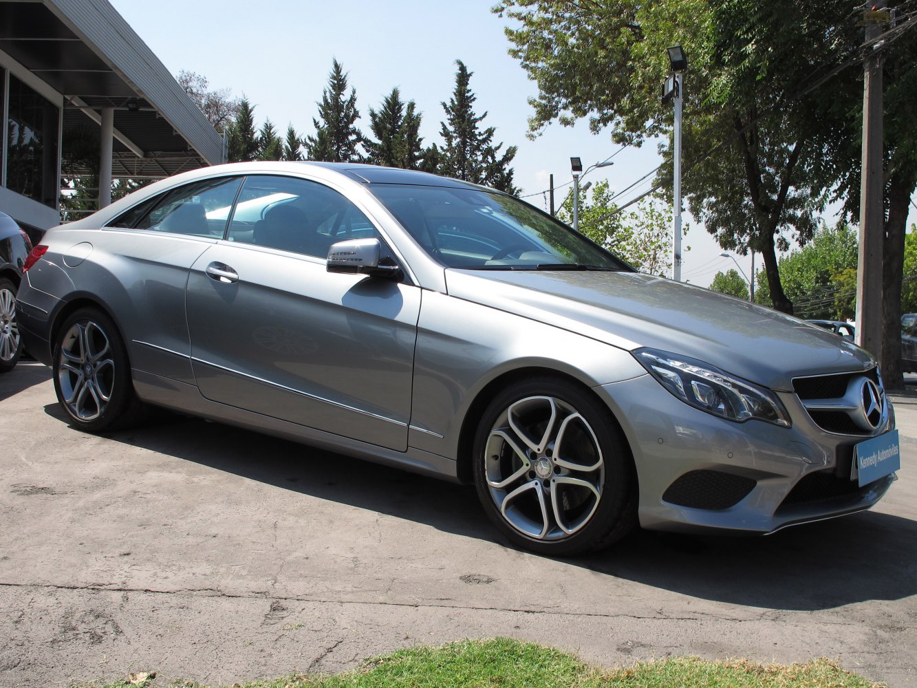 Silver two-door coupe with alloy wheels and sleek aerodynamic design