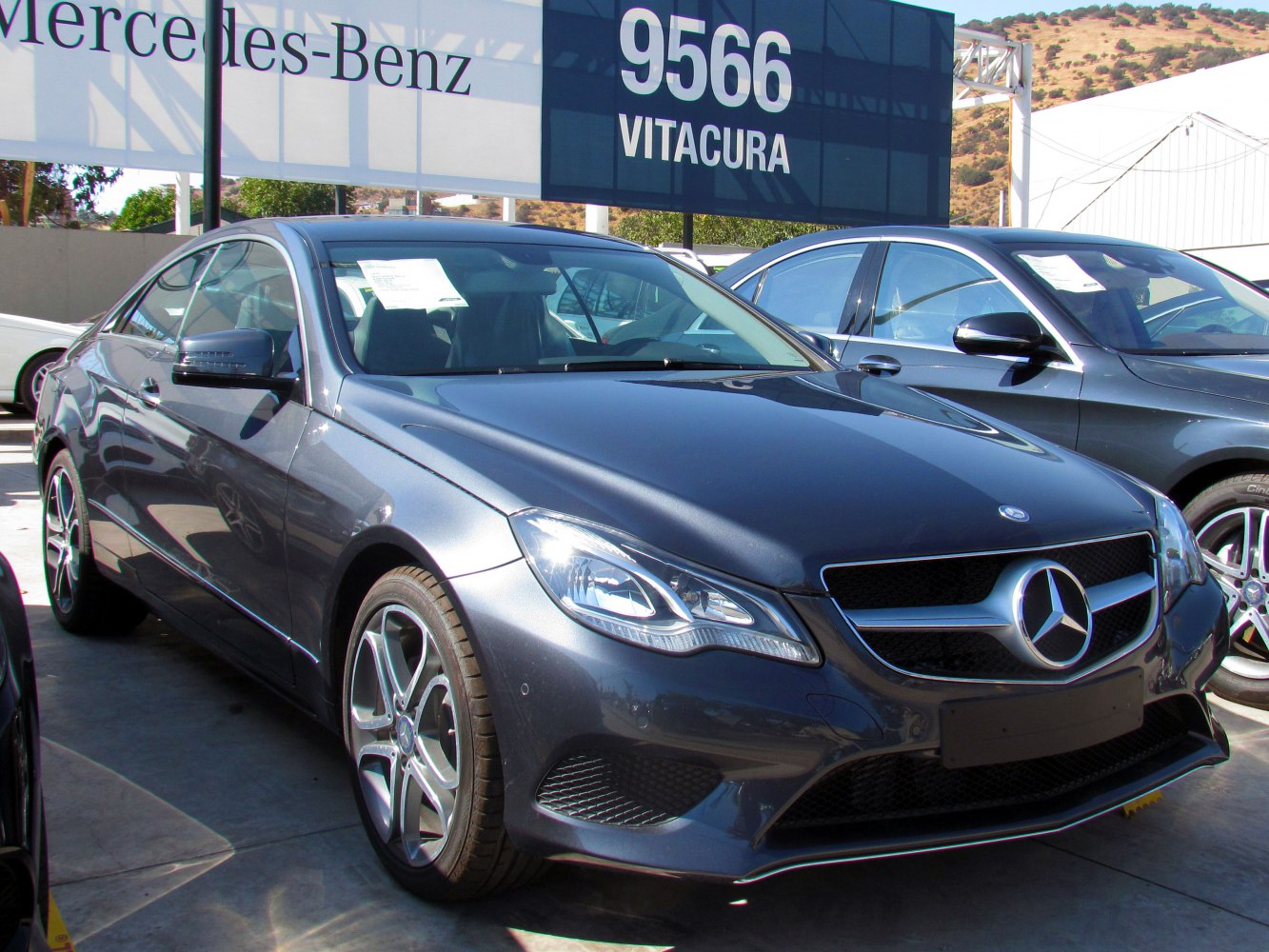 Front-side view of a sleek coupe with distinctive headlights and alloy wheels