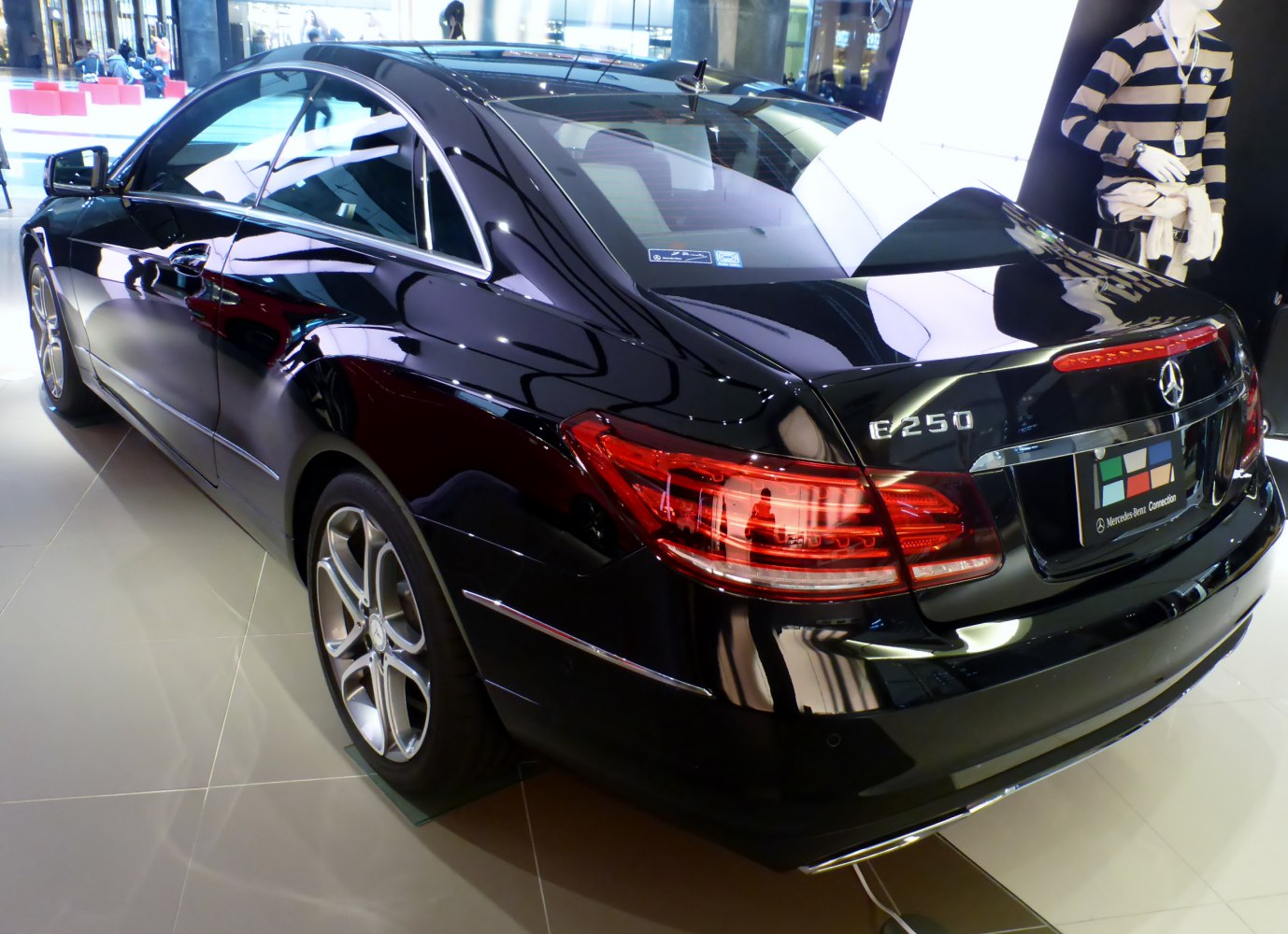 Rear three-quarter view with distinctive taillights and smooth coupe body lines