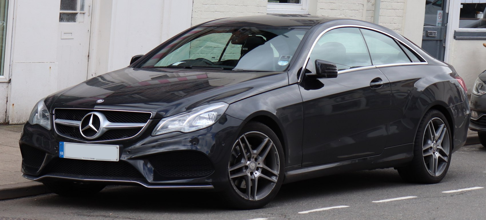 Sleek front grille and alloy wheels on black luxury coupe