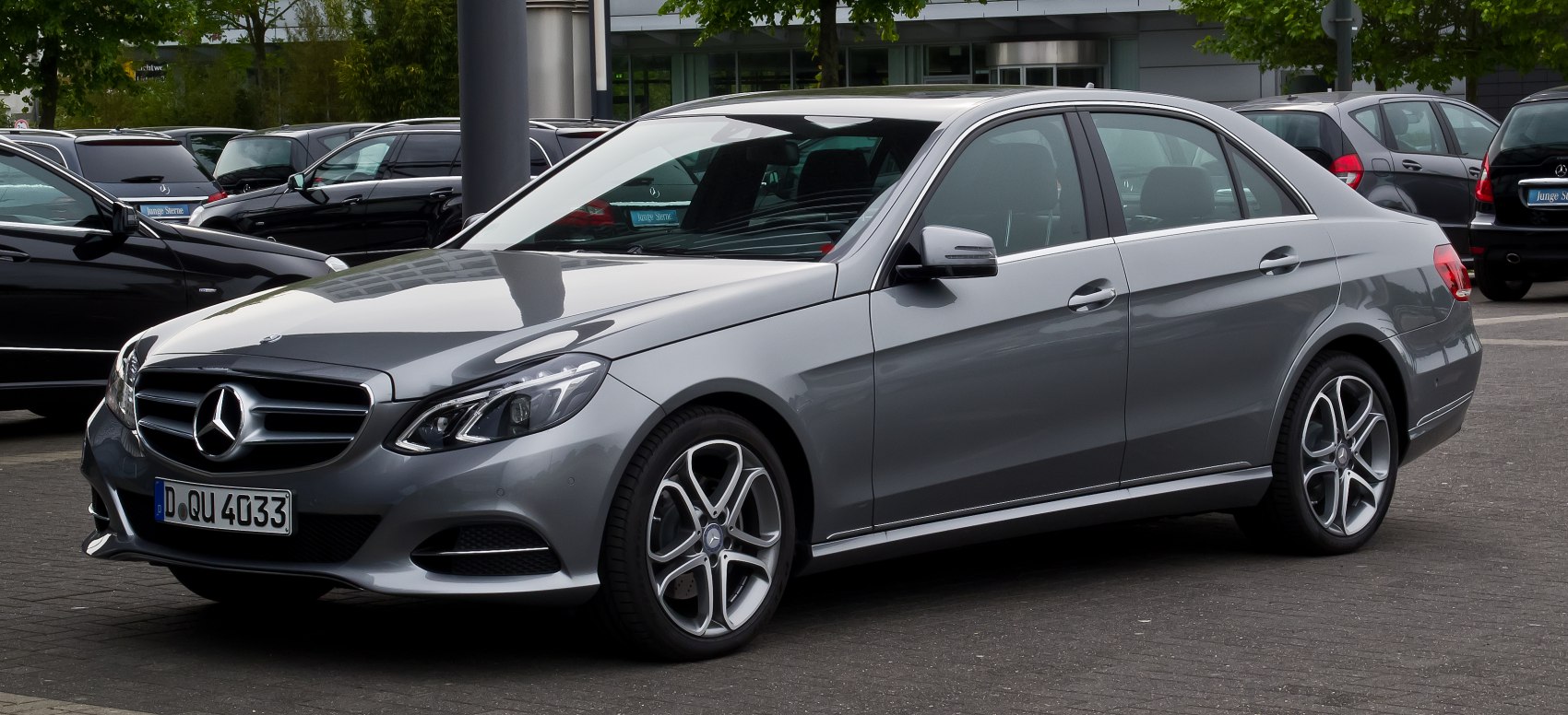 Gray luxury sedan with modern headlights and alloy wheels