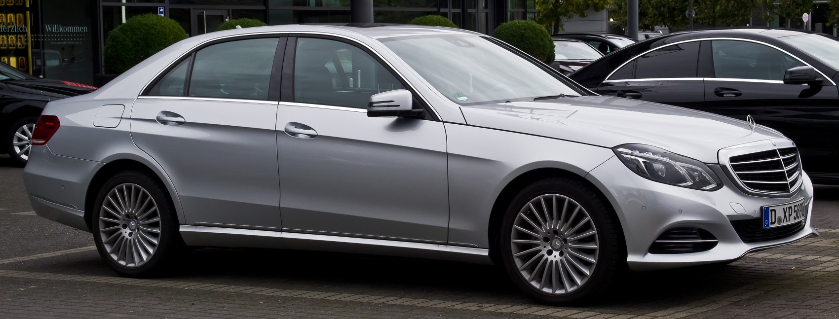 Silver sedan with distinct alloy wheels and front grille side profile