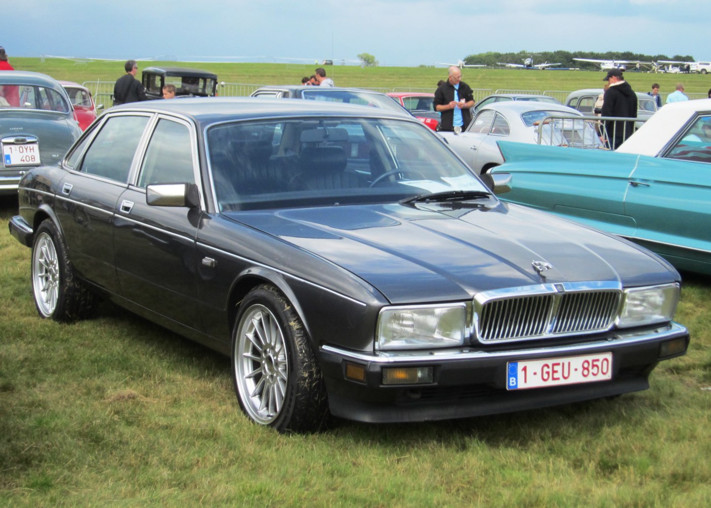 Front and side view of classic luxury sedan with distinctive grille and alloy wheels