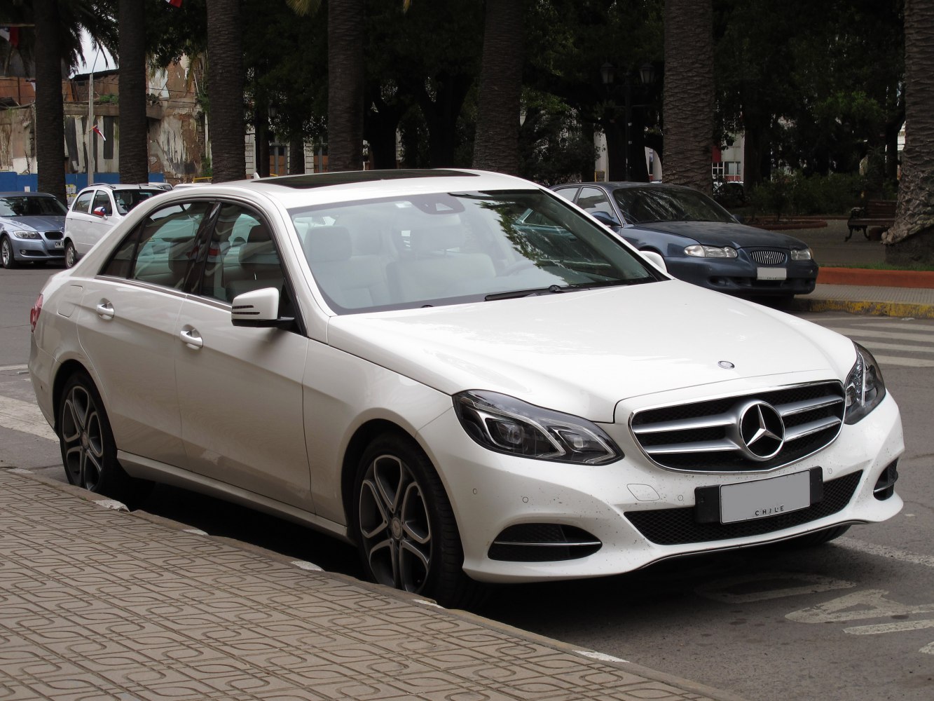 Front angled luxury sedan with LED headlights and alloy wheels