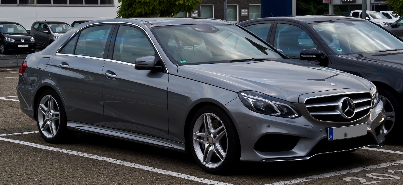 Gray sedan with aggressive front headlights and alloy wheels.