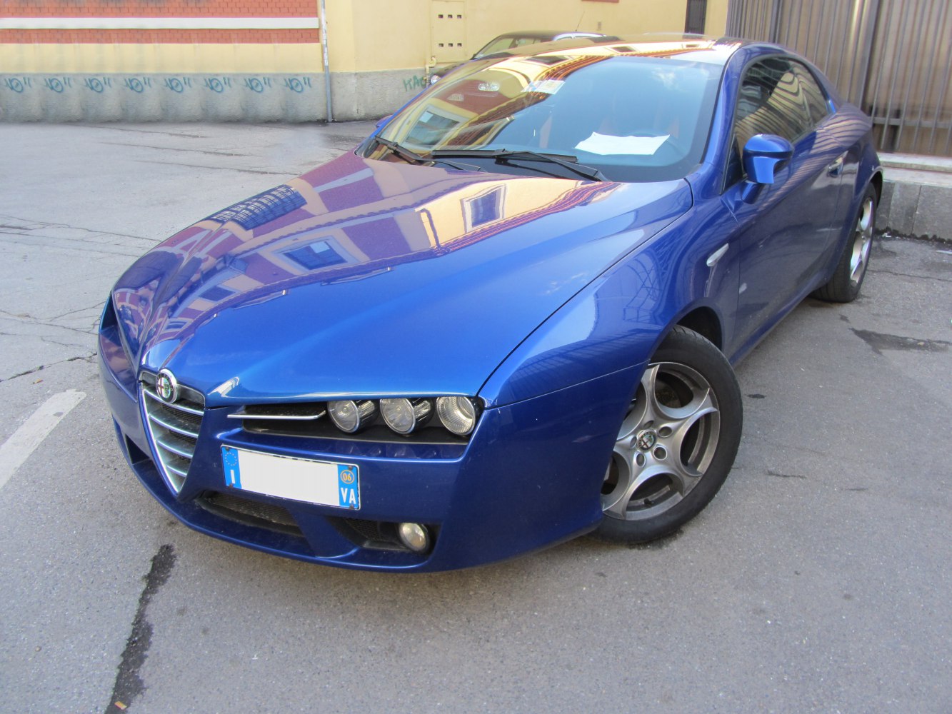 Front view with distinctive tri-headlights and sleek aerodynamic body