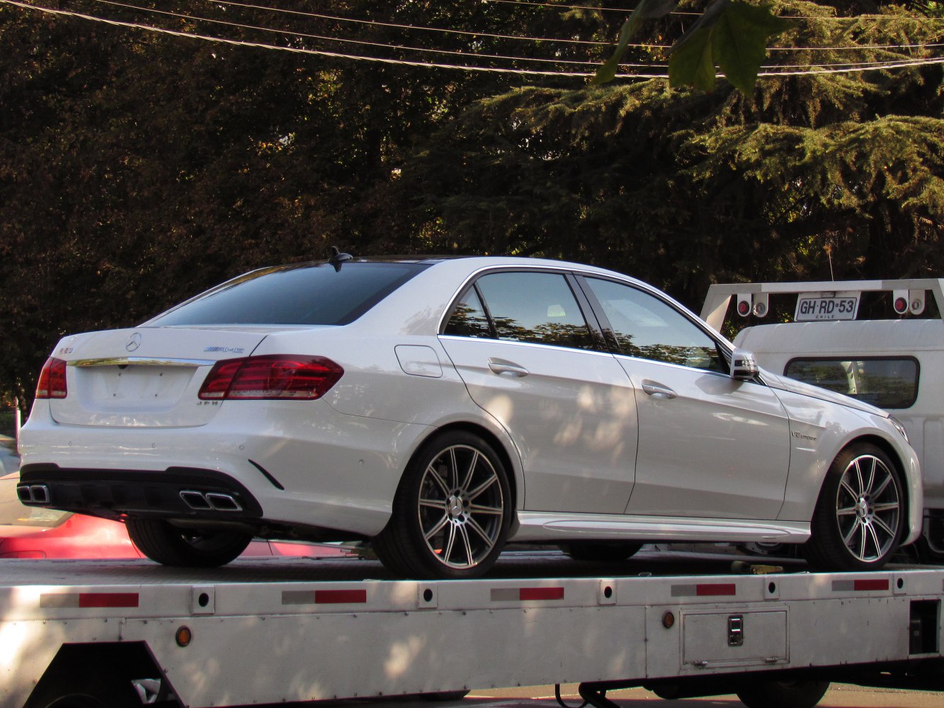 Rear and side view of luxury sedan with quad exhaust and alloy wheels
