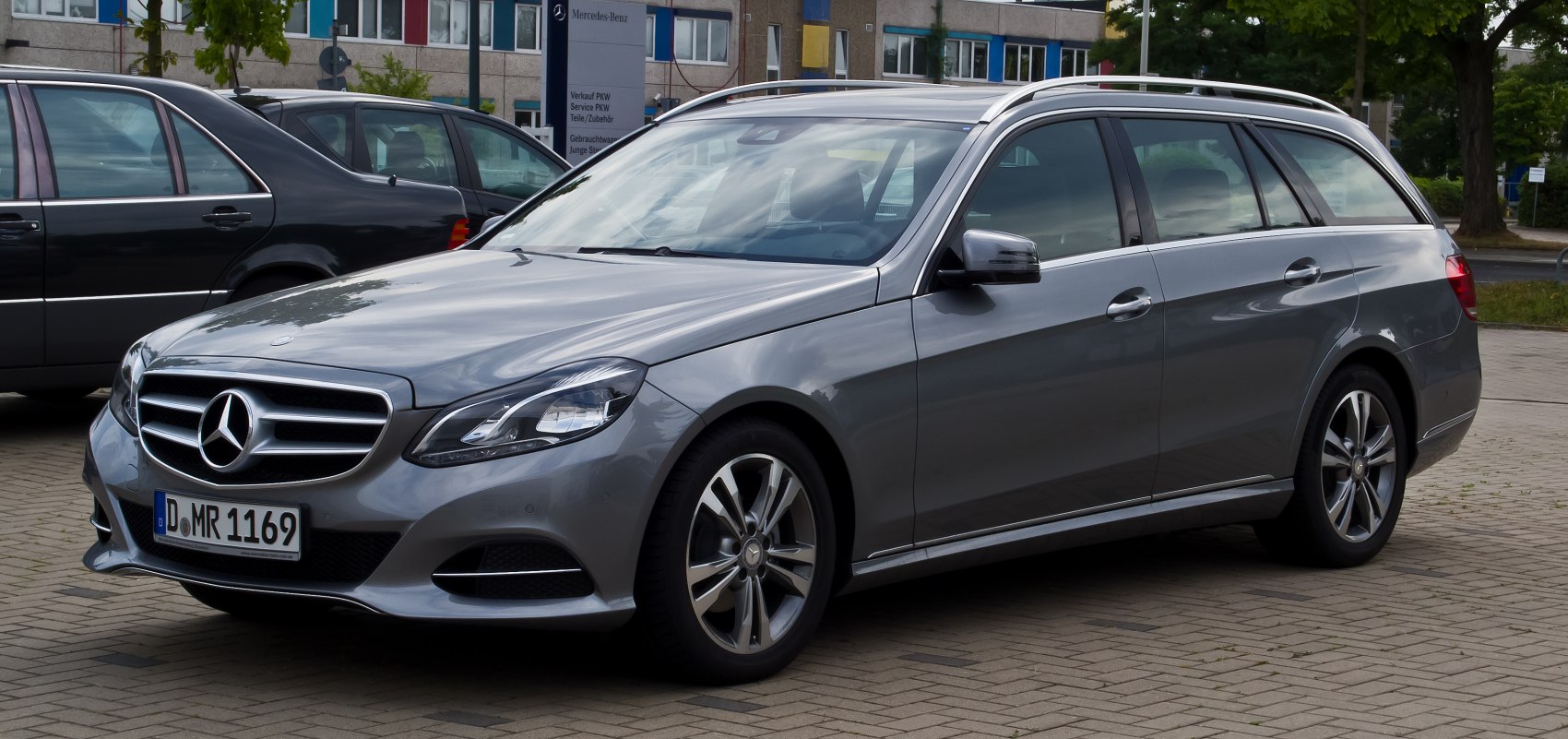 Silver station wagon with roof rails, front grille, alloy wheels