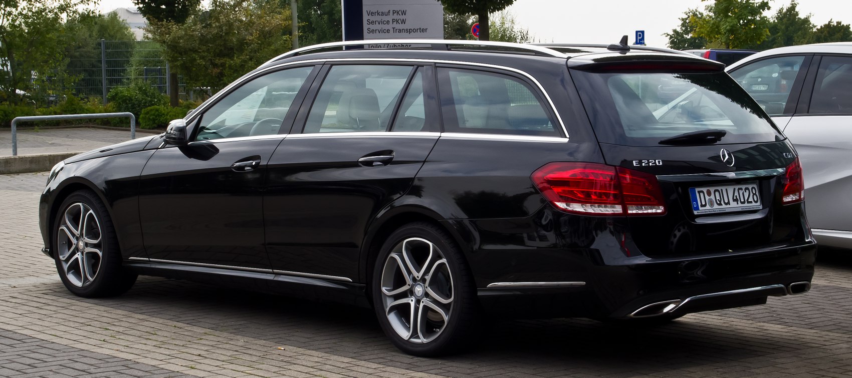 Rear side profile of black station wagon with alloy wheels