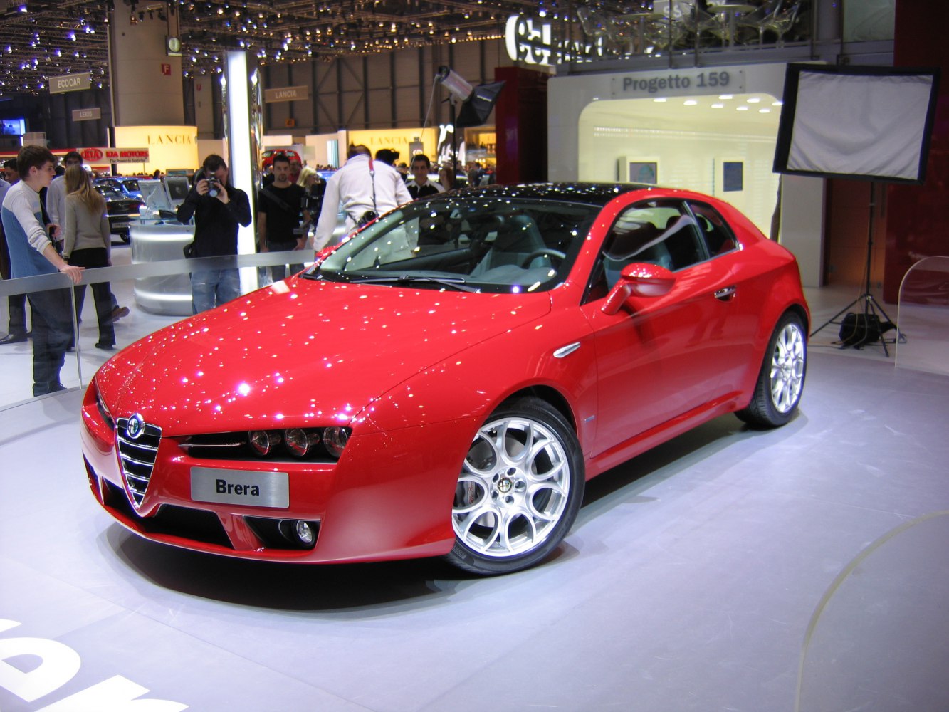 Red sports coupe with unique front lights and alloy wheels