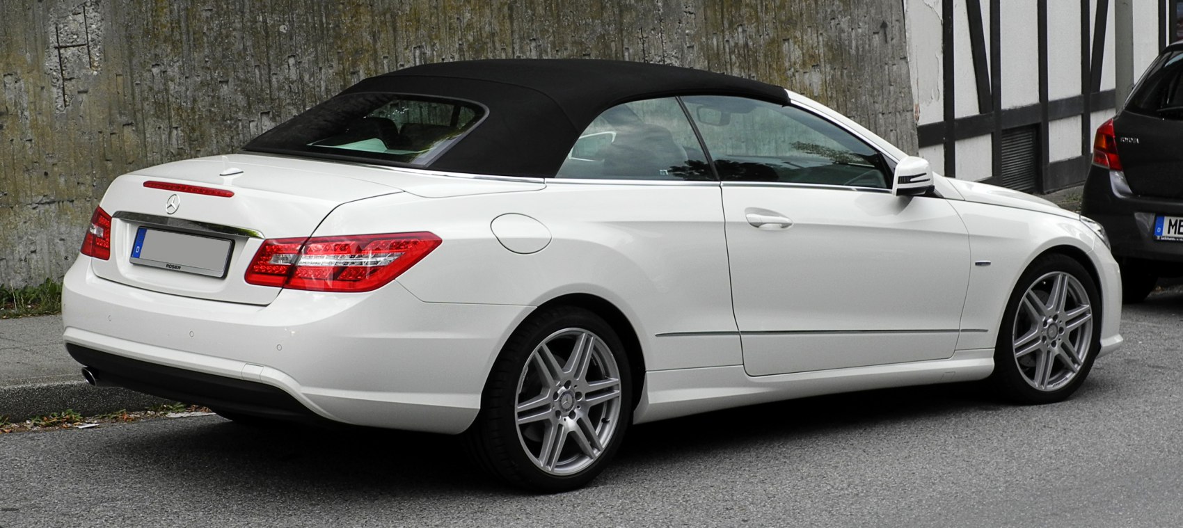 White convertible with black soft top and LED tail lights