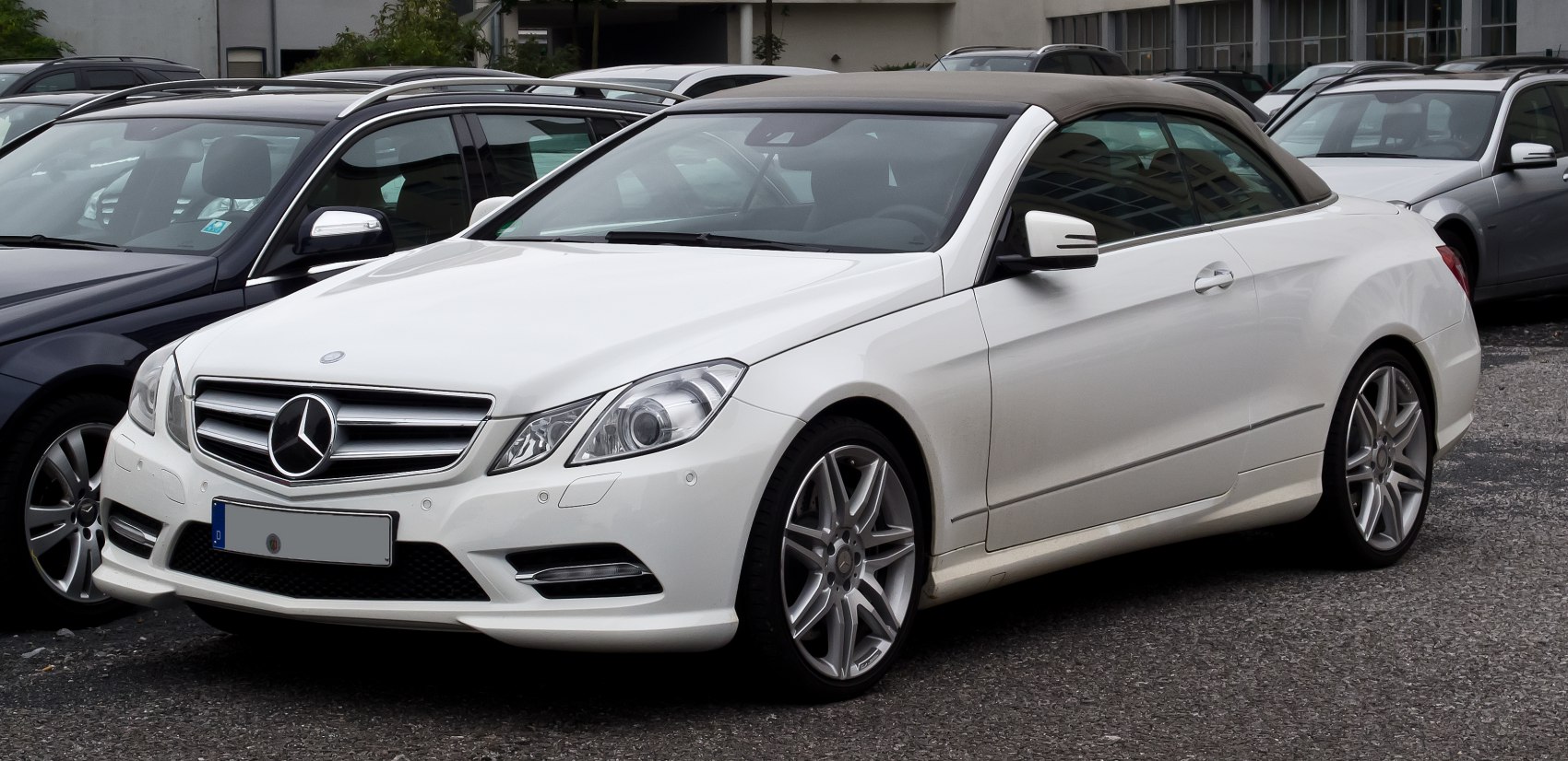 White convertible with soft top and alloy wheels