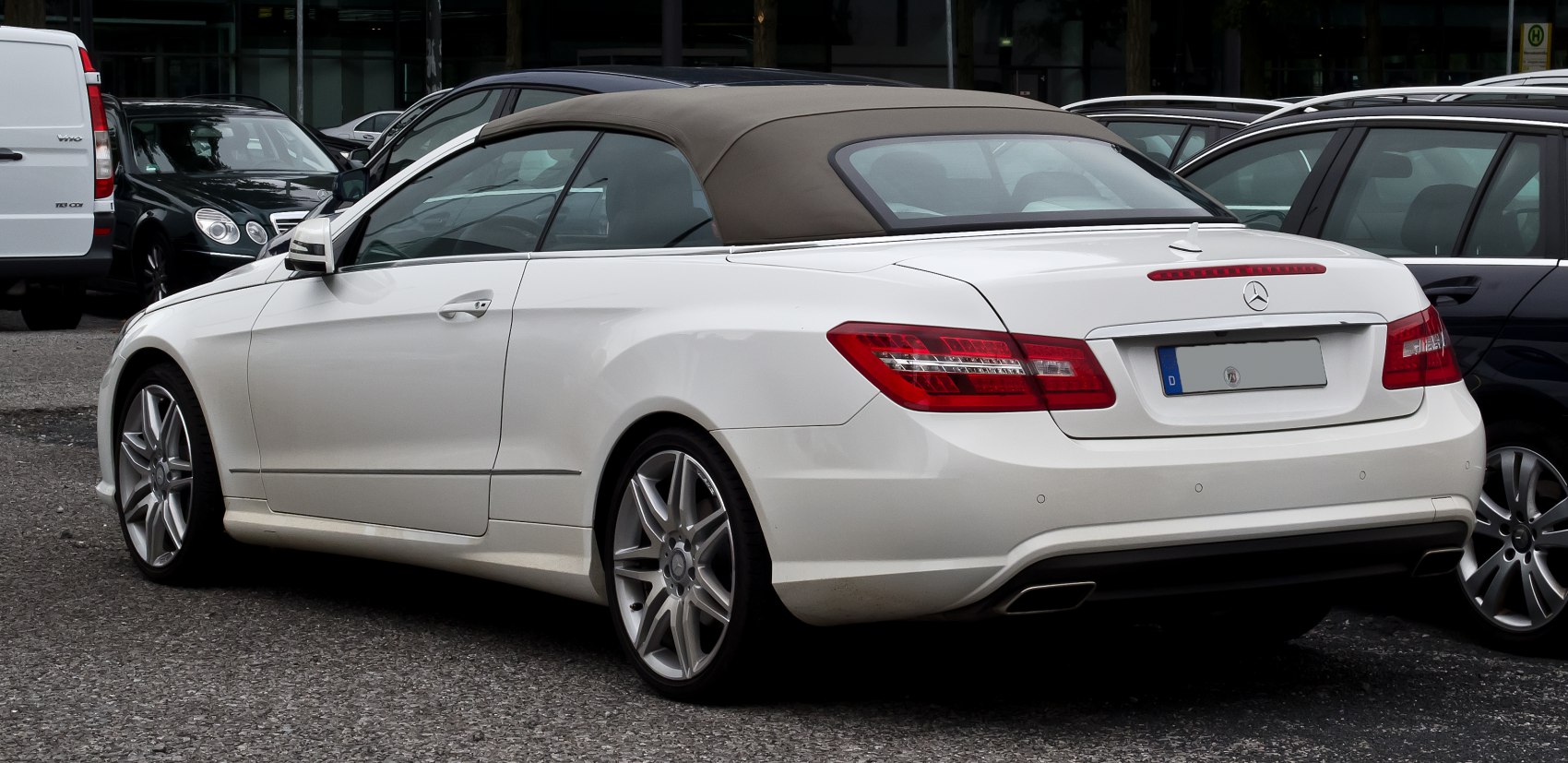 Convertible with beige soft top, LED taillights, and alloy wheels