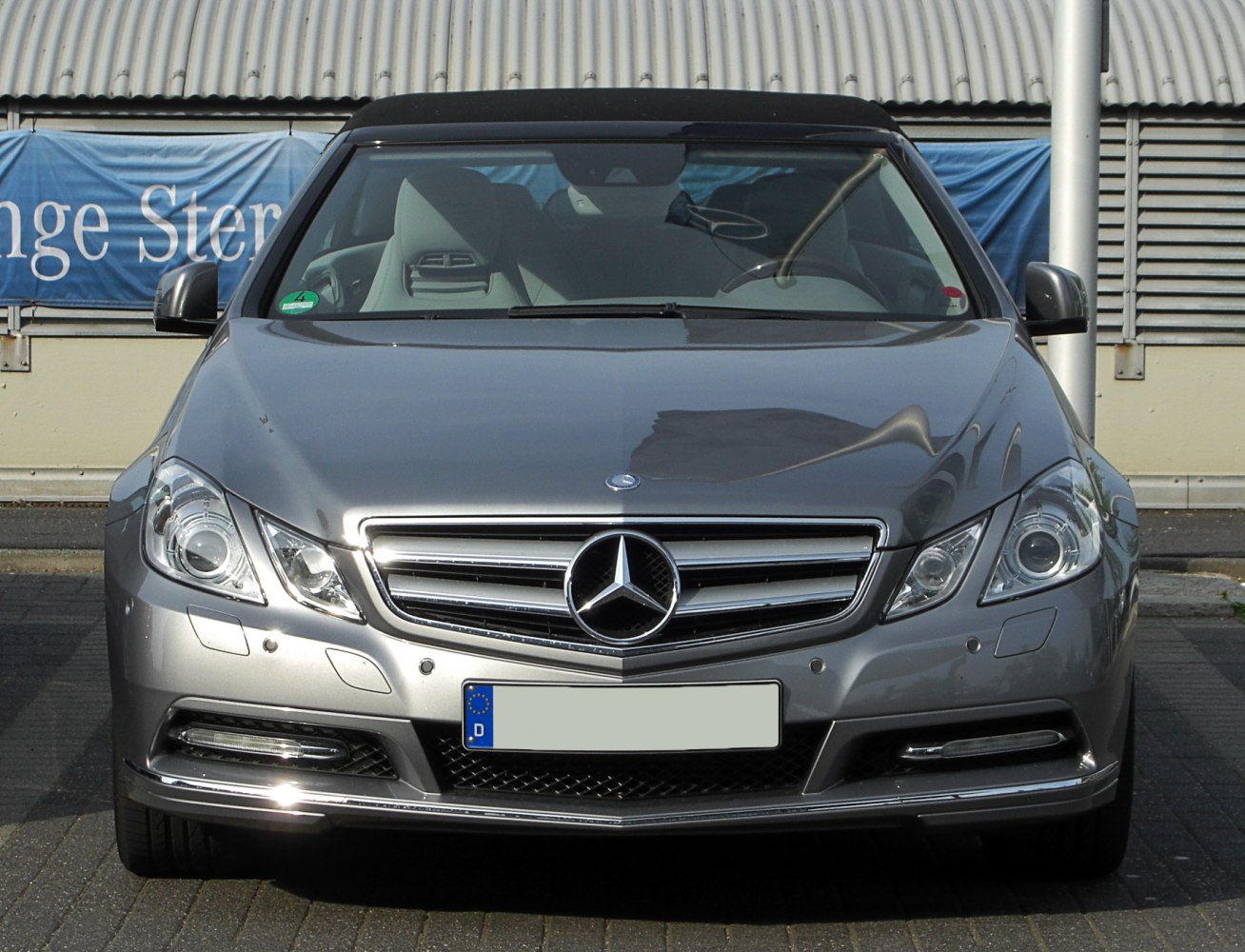 Front view with grille, headlights, and soft top roof