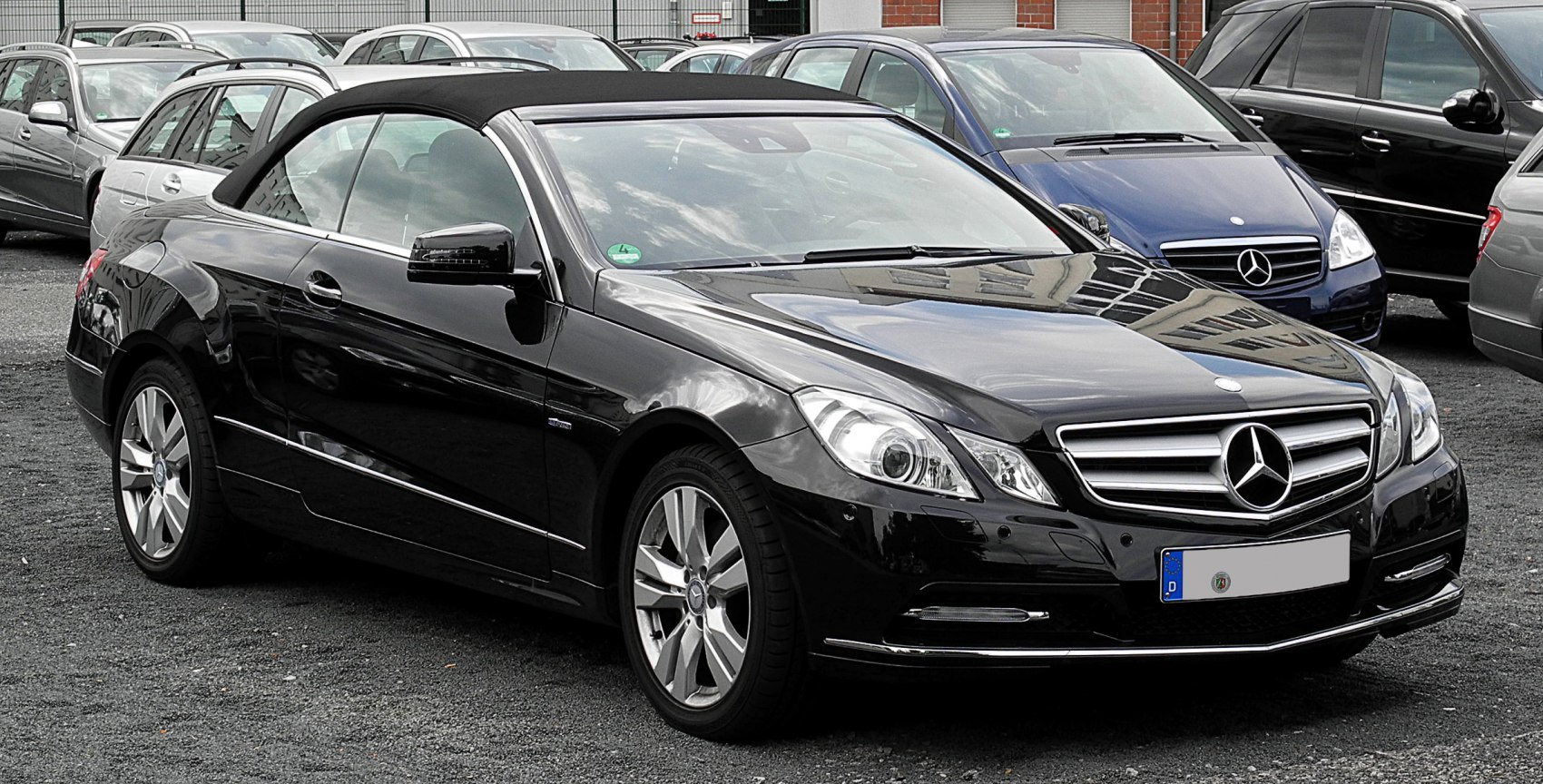 Front-side view of black convertible with soft top roof
