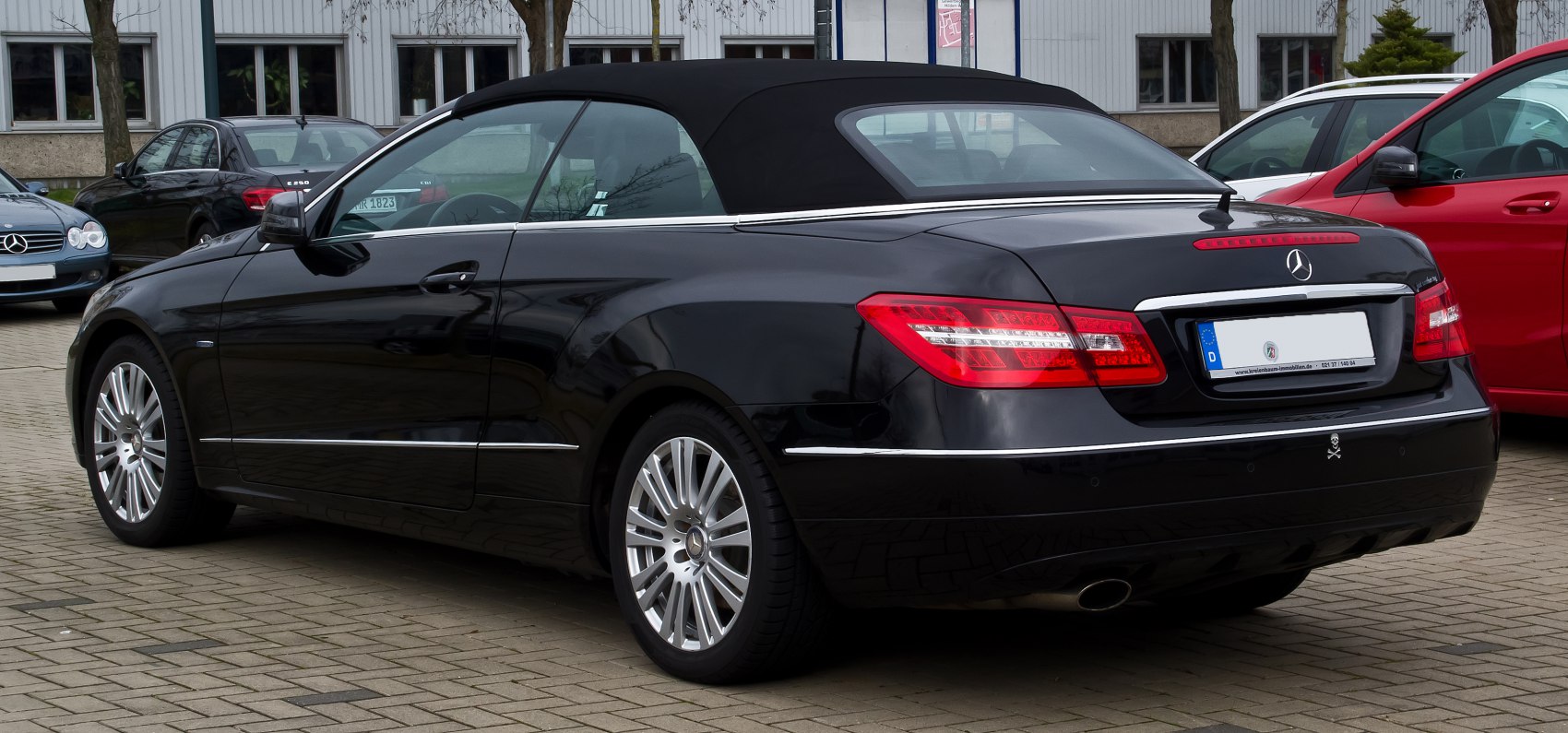 Black convertible with soft fabric roof and rear LED lights