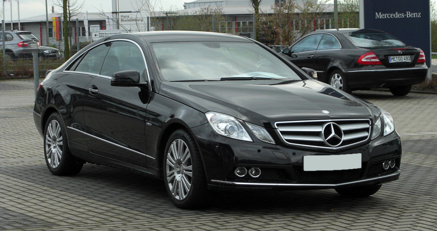 Front and side view of luxury coupe with stylish headlights and alloy wheels