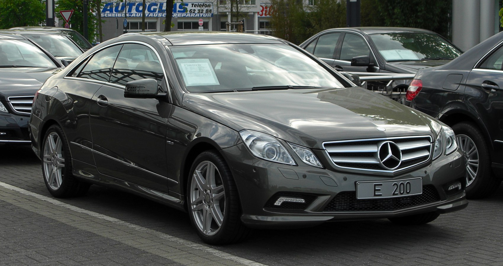 Front side view of a luxury coupe with distinctive grille and sleek lines