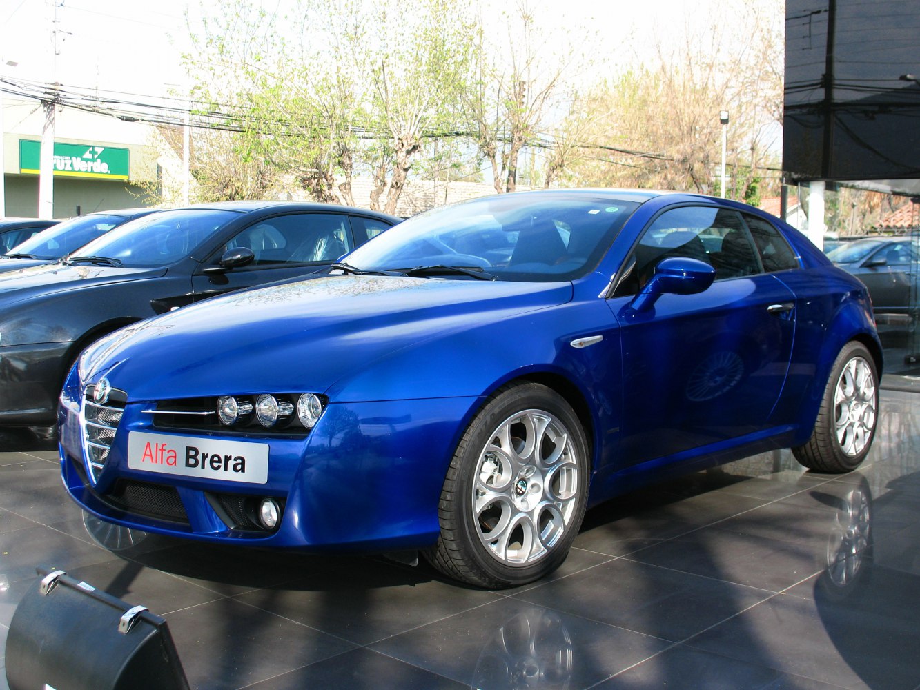 Blue sports coupe with distinctive grille and round headlamps