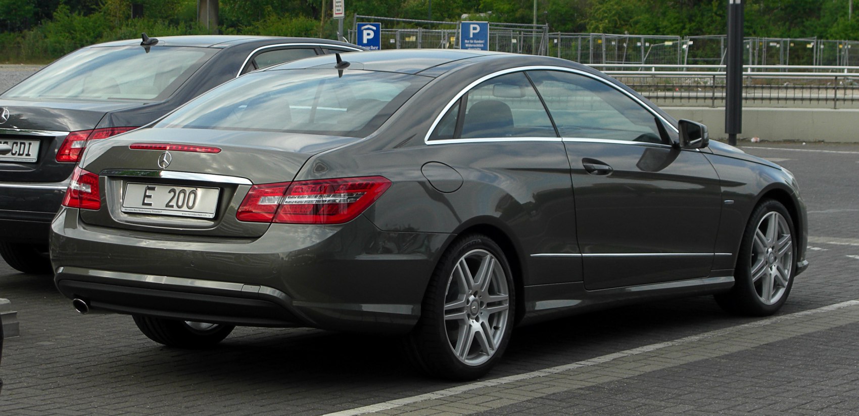 Sleek rear and side profile of a luxury coupe with distinctive taillights