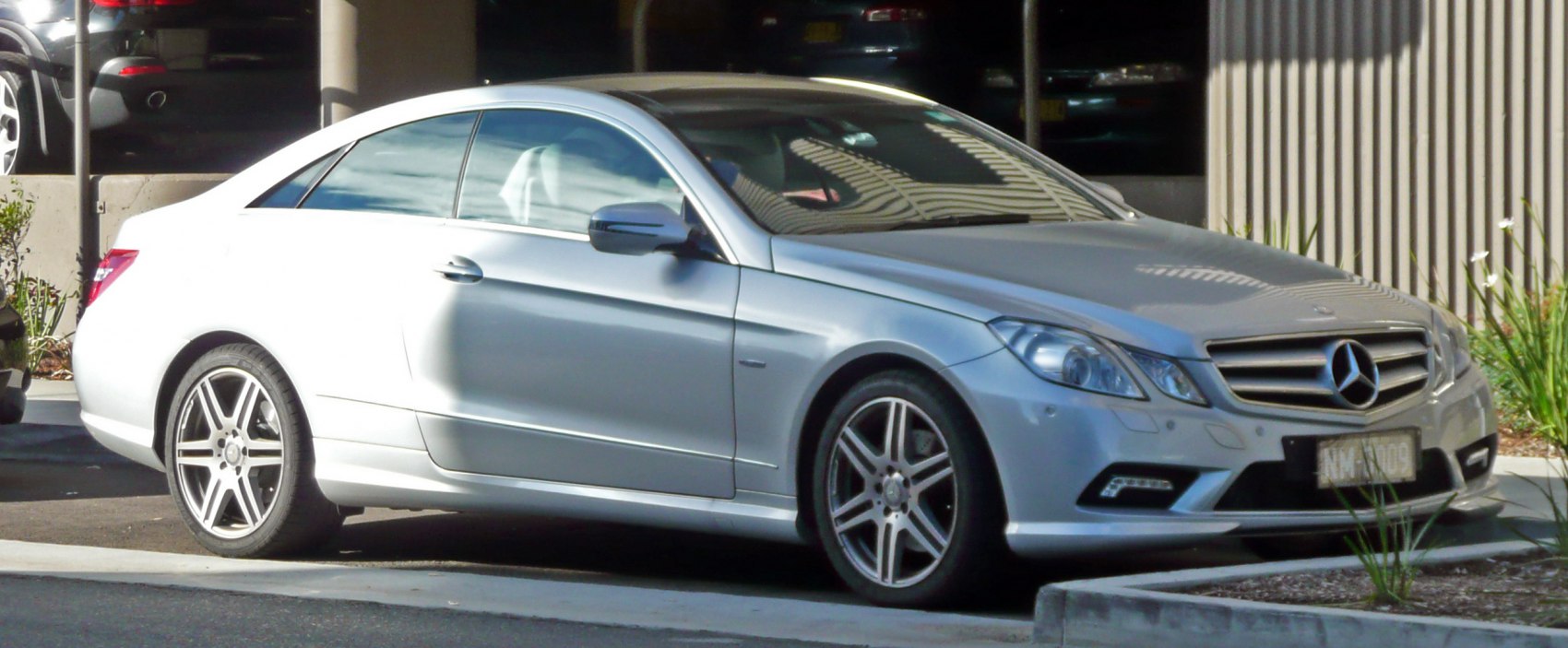 Front-side view of a silver two-door coupe with alloy wheels