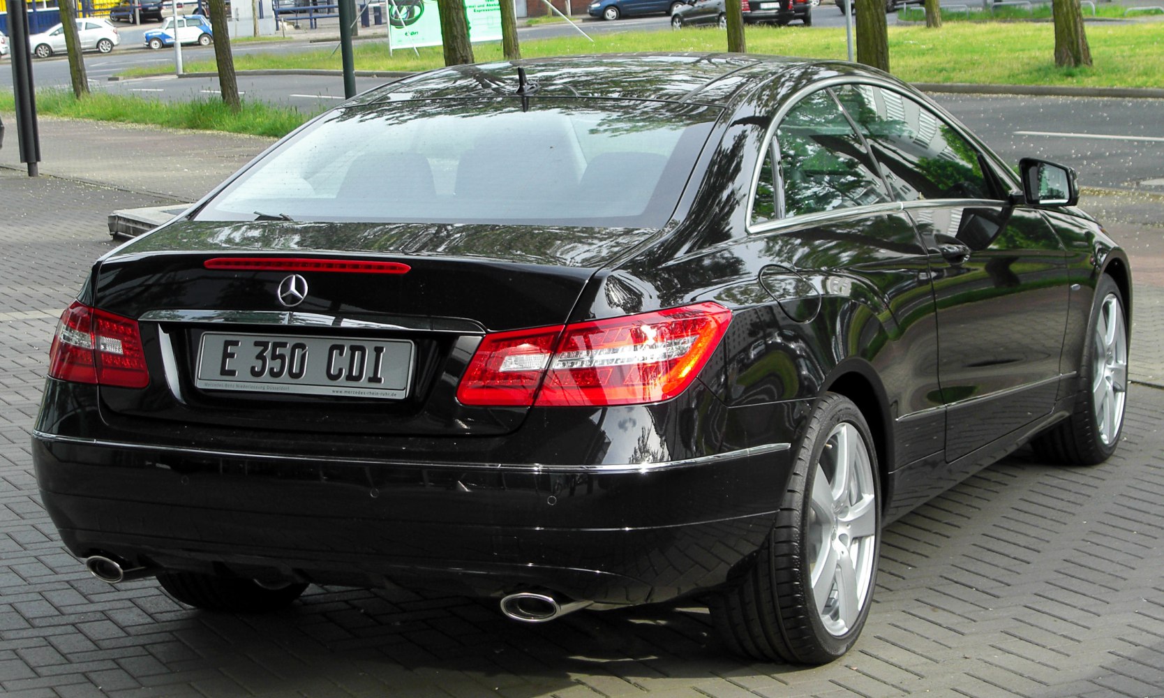 Sleek coupe rear with LED tail lights and dual exhausts