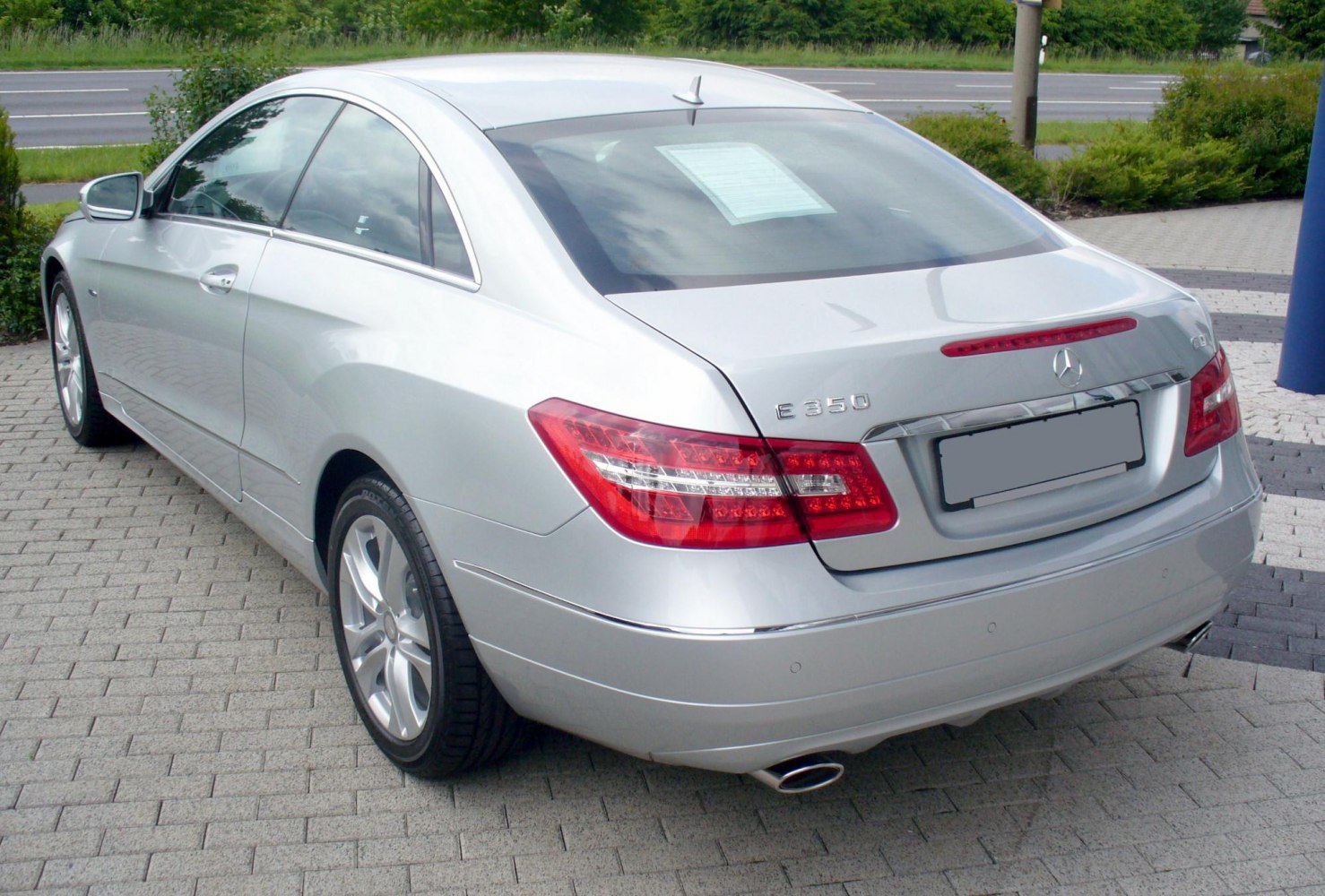 Sleek coupe rear with LED taillights and dual exhaust pipes