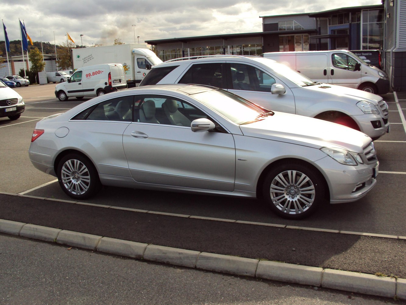 Silver two-door coupe with multi-spoke wheels and sleek body design.