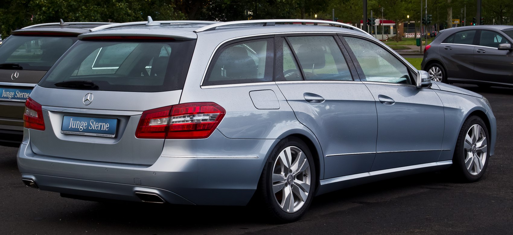 Rear and side profile of a silver station wagon with dual exhaust and roof rails