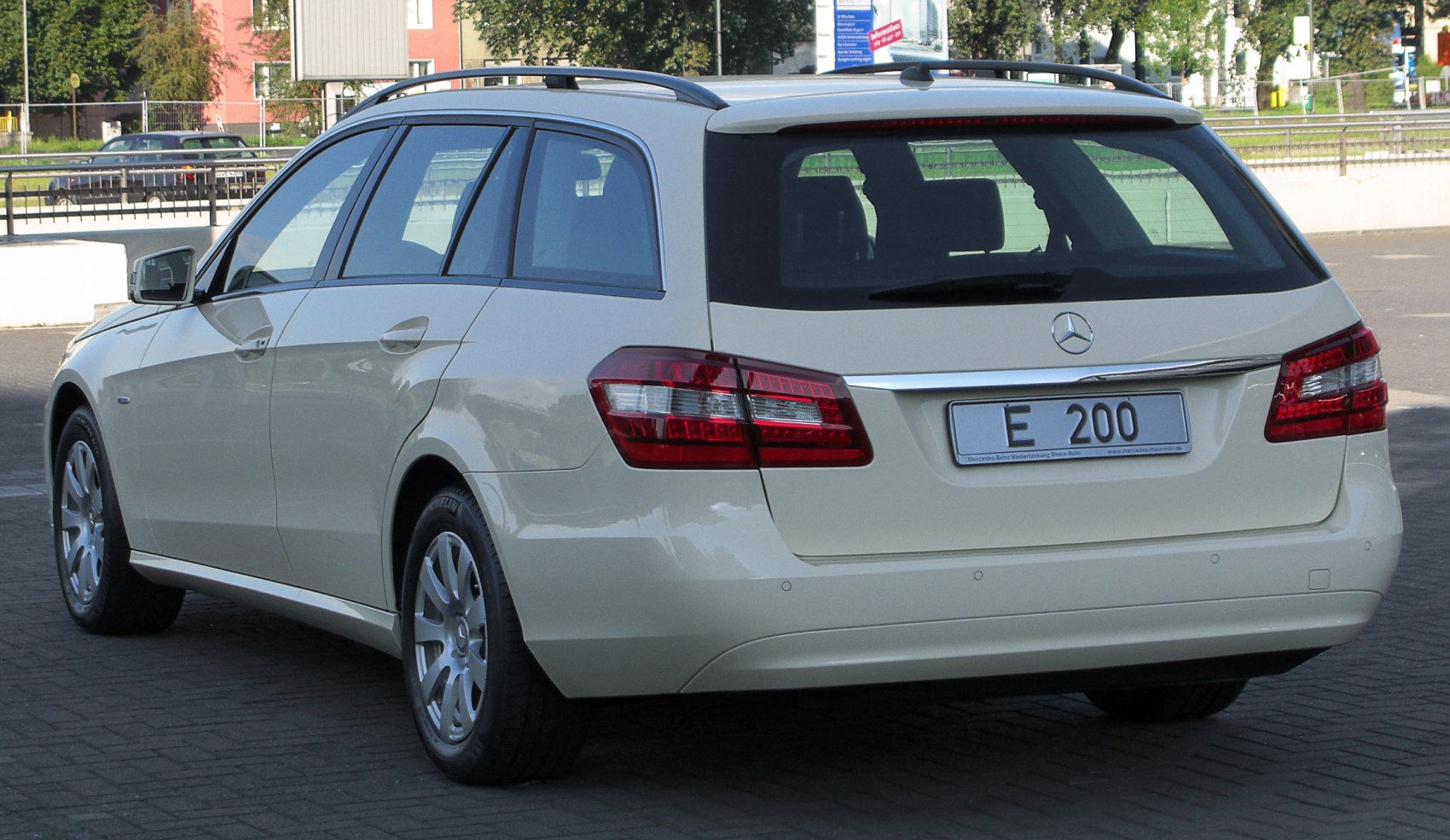 Rear of a station wagon with roof rails and distinct tail lights