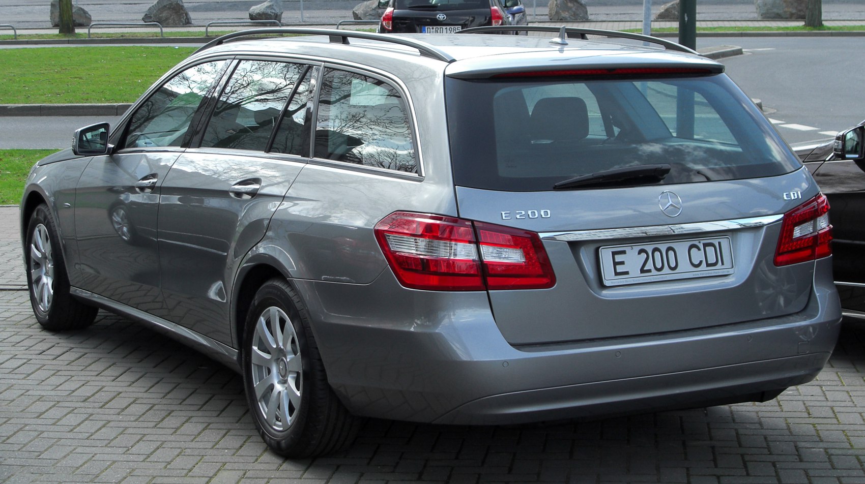 Rear view of a grey station wagon showing taillights and rear design.