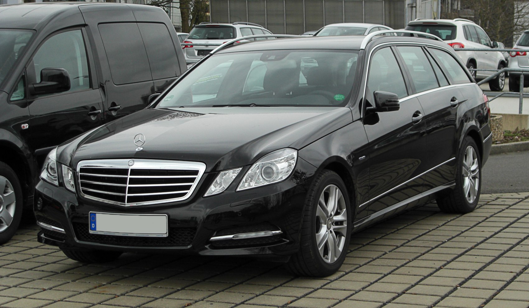 Front-side view of luxury station wagon with grille and headlights