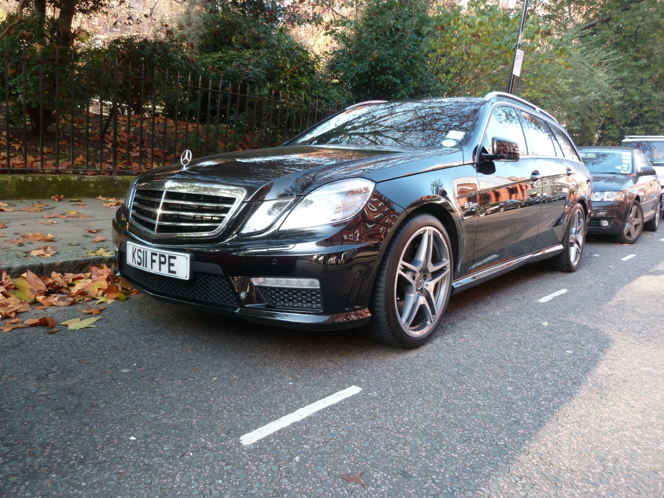 Black station wagon with AMG wheels and chrome grille details.