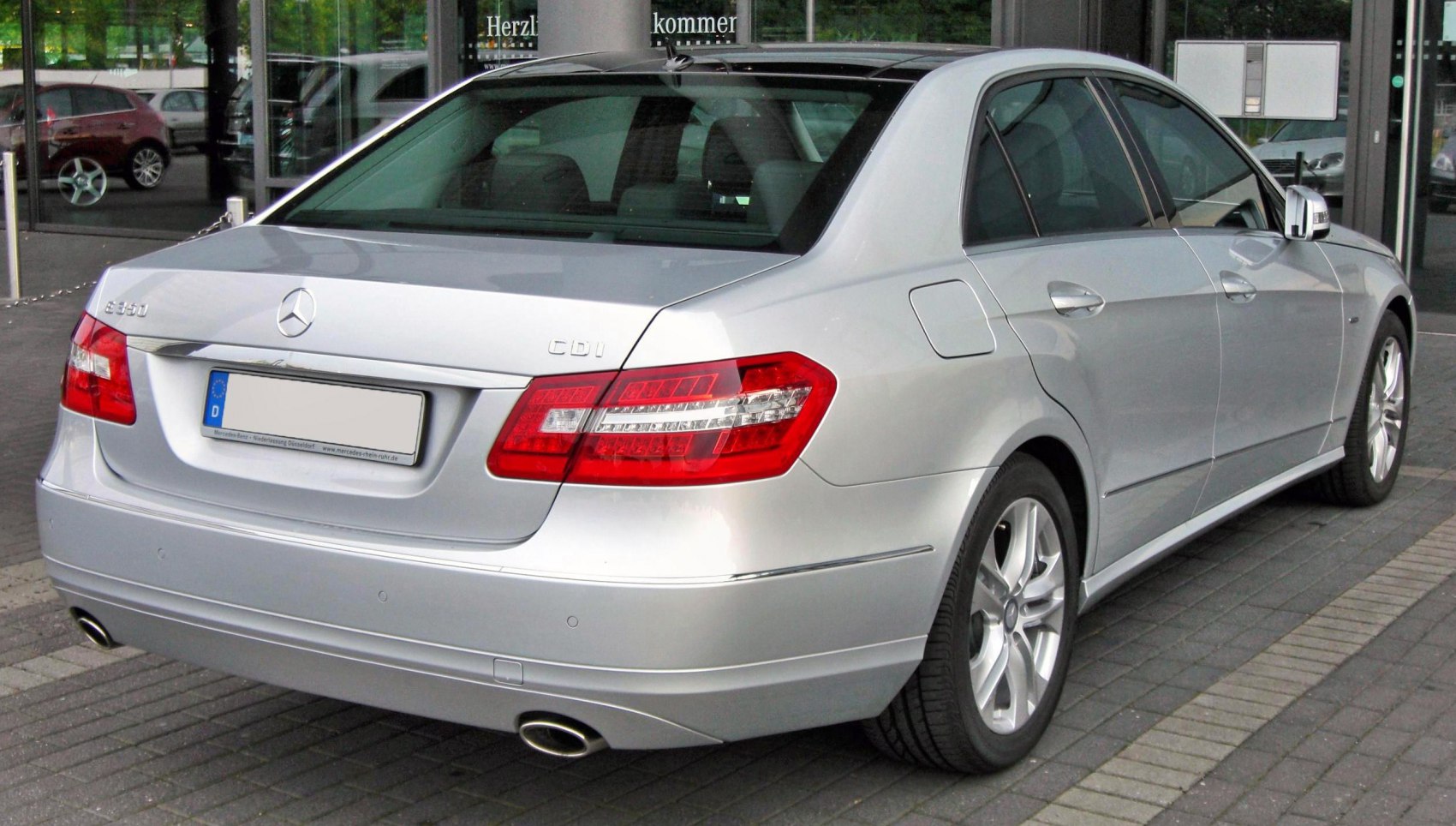 Silver sedan rear with LED tail lights and dual exhaust