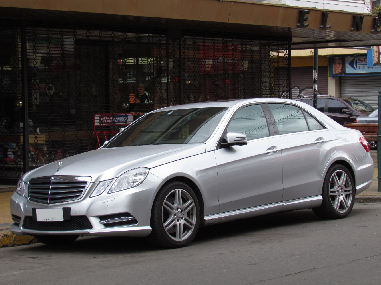 Silver luxury sedan with prominent front grille and alloy wheels