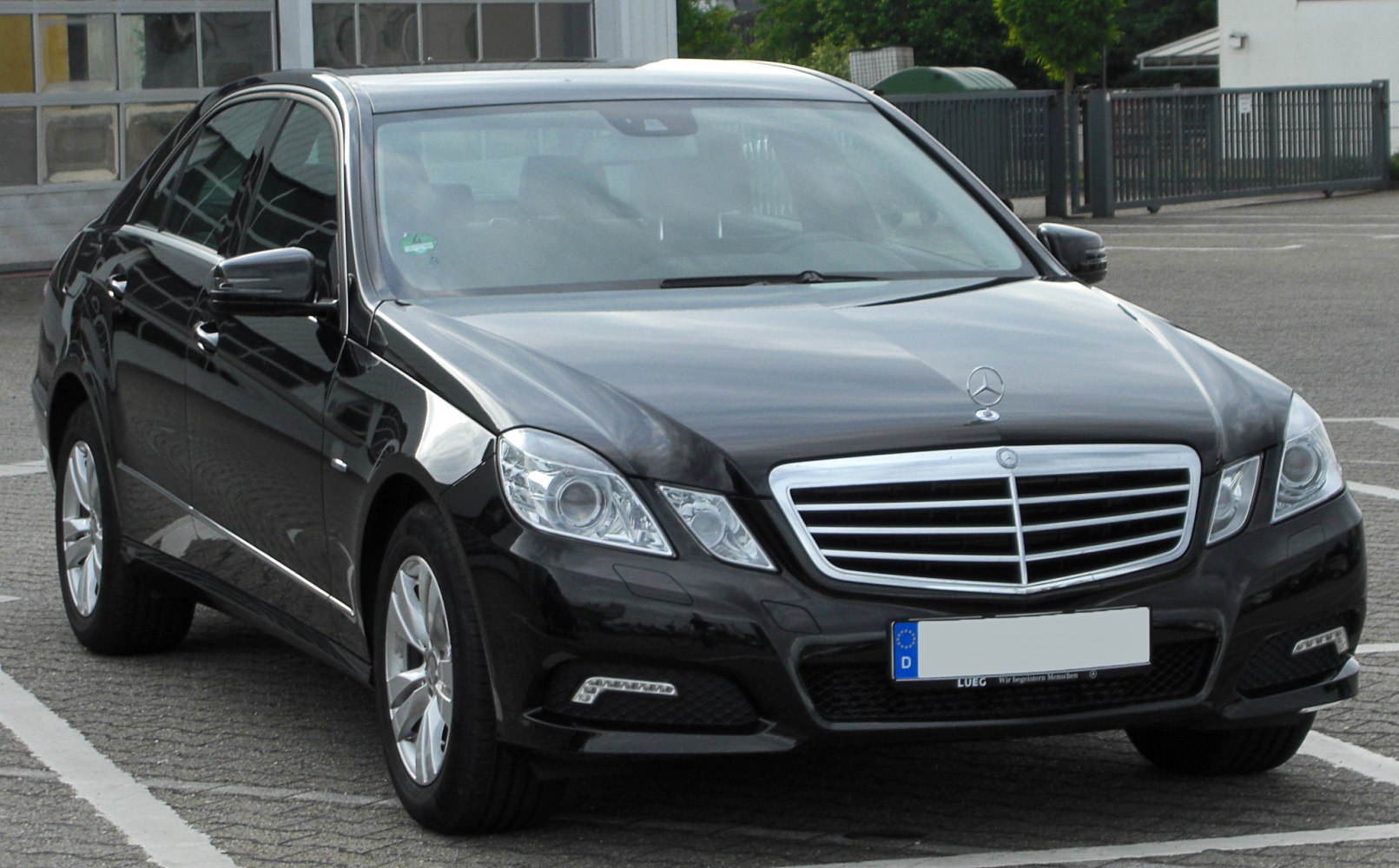 Front view of a black luxury sedan with prominent grille and headlights.