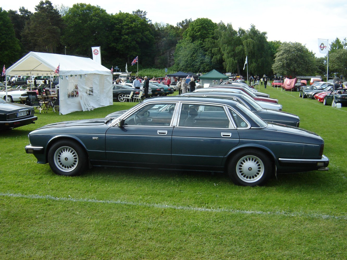 Long-wheelbase luxury sedan with chrome trim and unique circular wheel design
