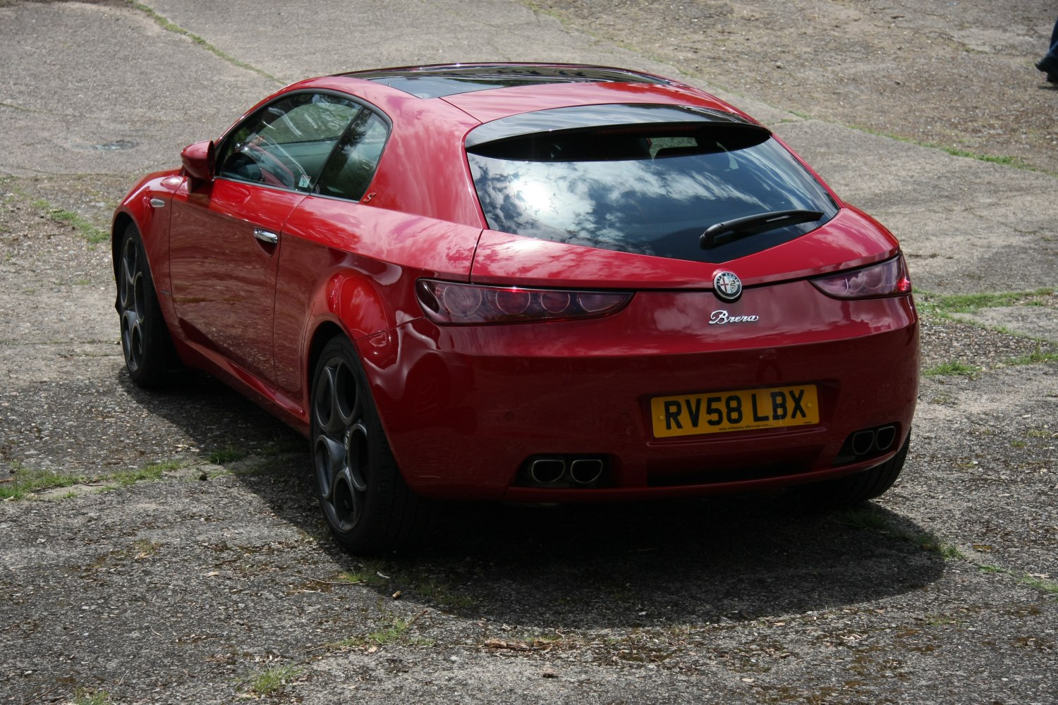 Rear view with quad exhaust pipes and sleek rear tail lights