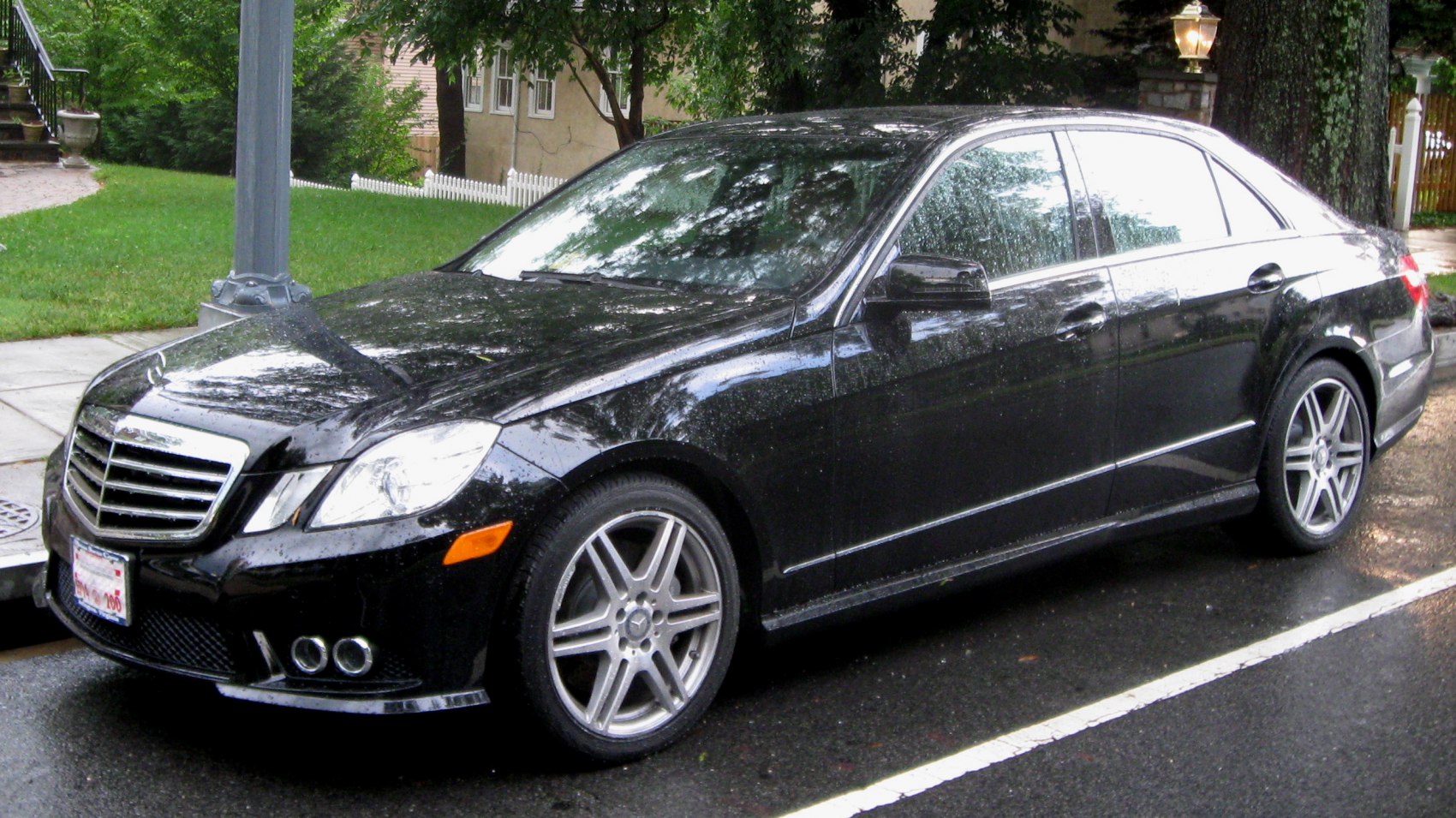 Black luxury sedan parked showing front and side profiles