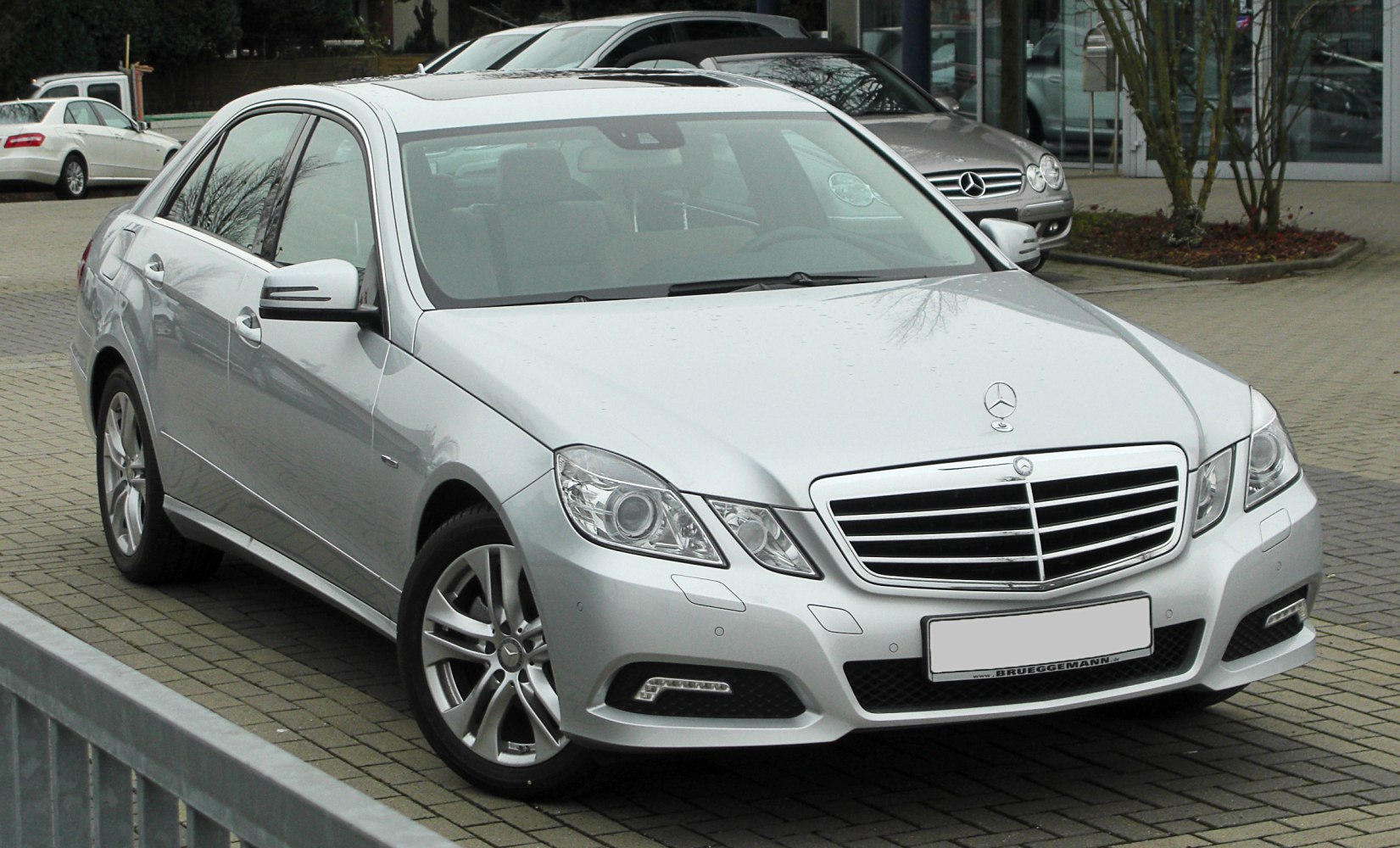 Silver four-door sedan front with LED lights and alloy wheels