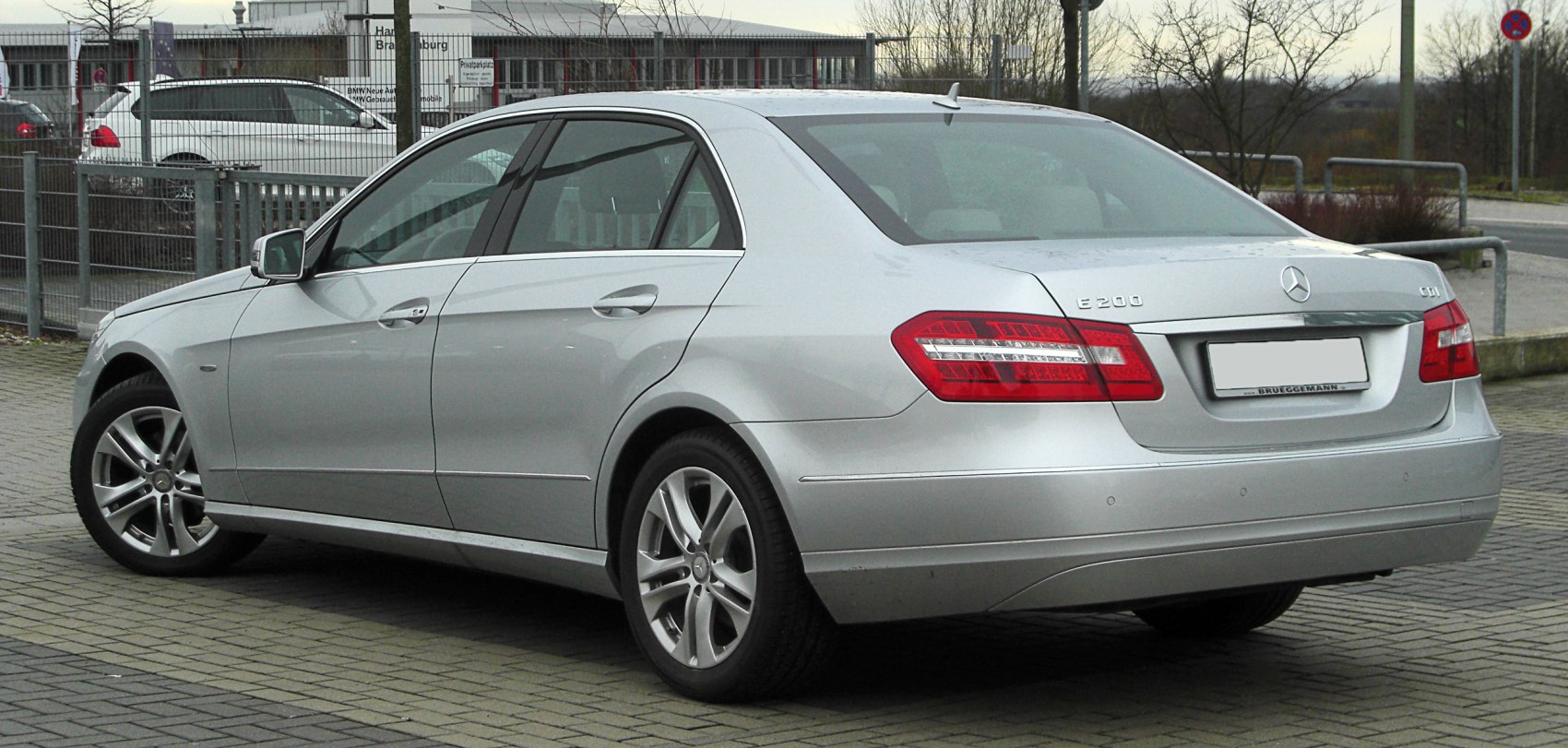 Silver luxury sedan rear and side profile with sleek taillights and alloy wheels