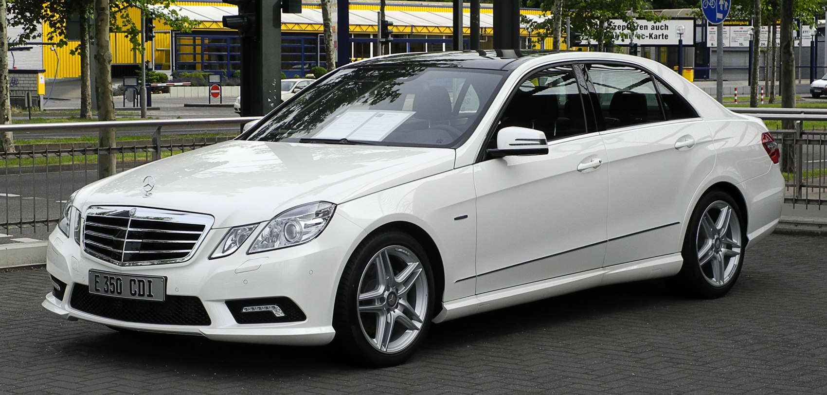 White sedan with chrome grille and sporty alloy wheels front side view