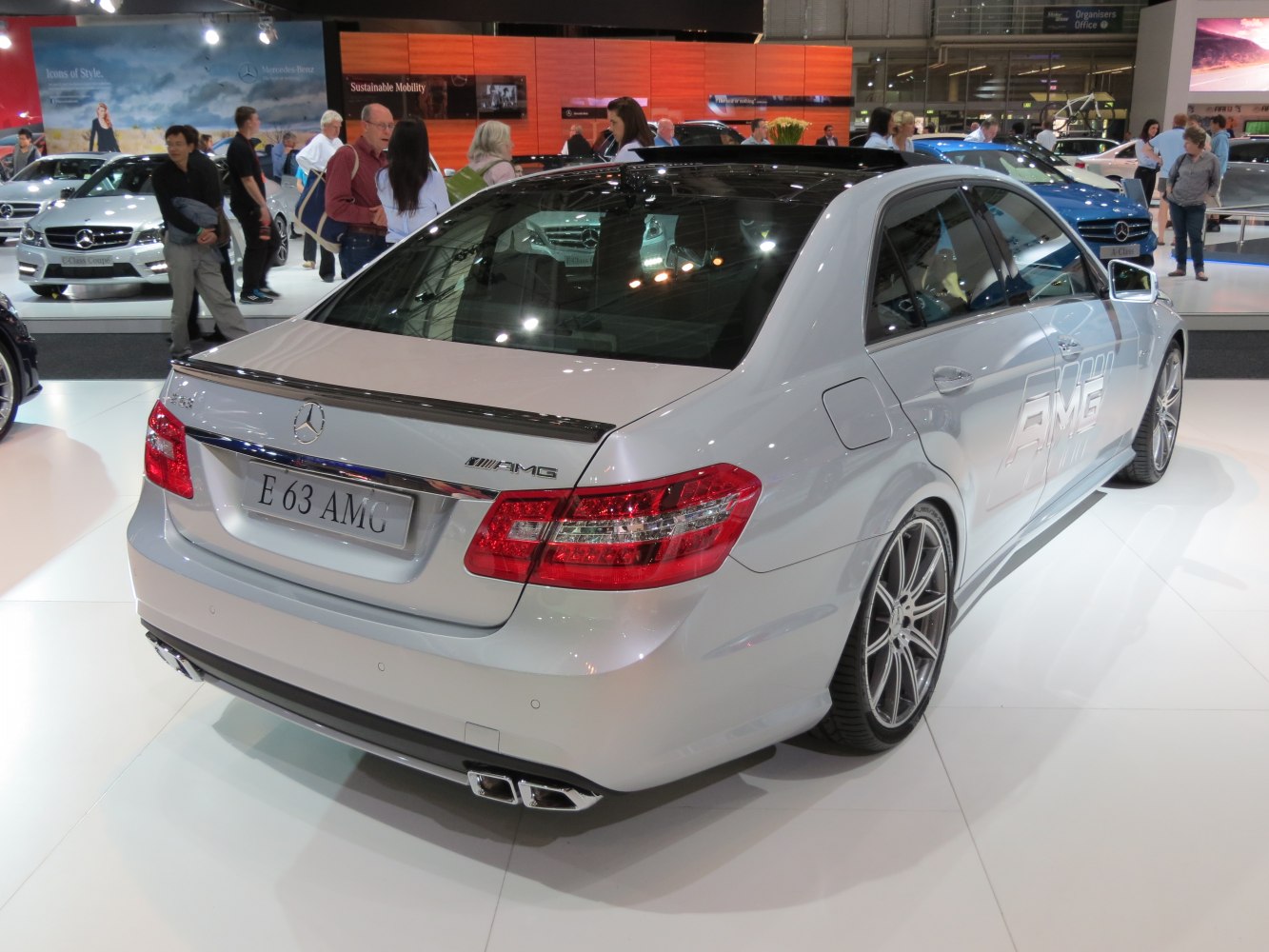 Silver AMG sedan rear and side view with quad exhausts and sporty rims