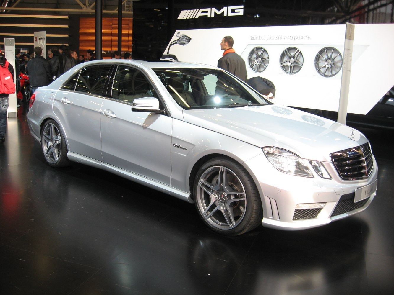 Silver luxury sedan front side view with AMG wheels and sporty design