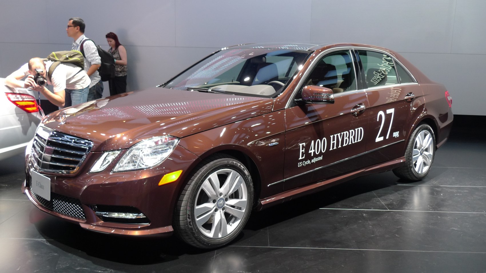 Front and side view of a luxury sedan with hybrid badging and alloy wheels
