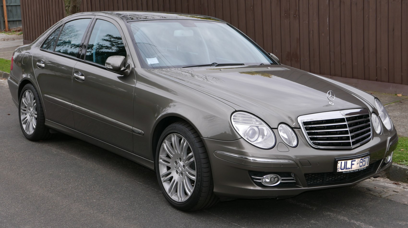 Front and side view with prominent grille and dual headlights