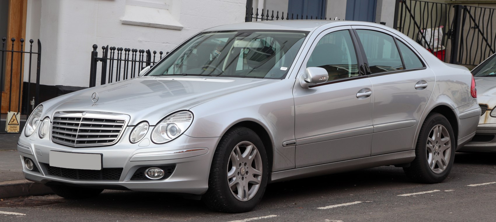 Silver luxury sedan with distinctive headlights and grille.