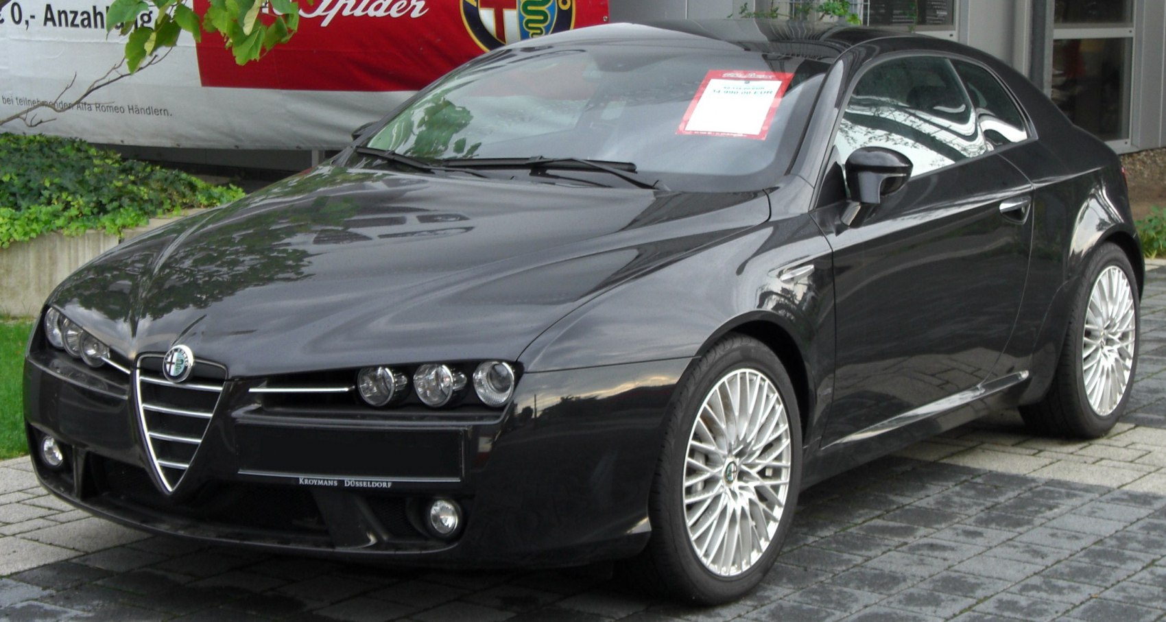 Triple headlights and alloy wheels on a sleek coupe front angle